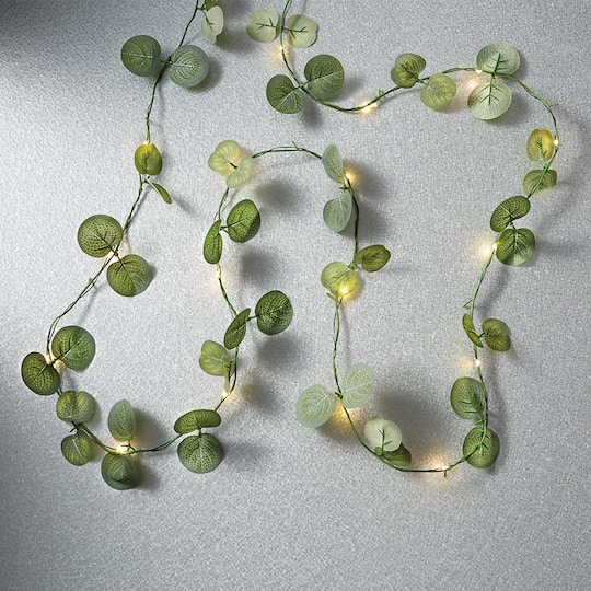 12 Pack: 18ct. Warm White LED String Lights Eucalyptus Leaf Garland by Ashland®